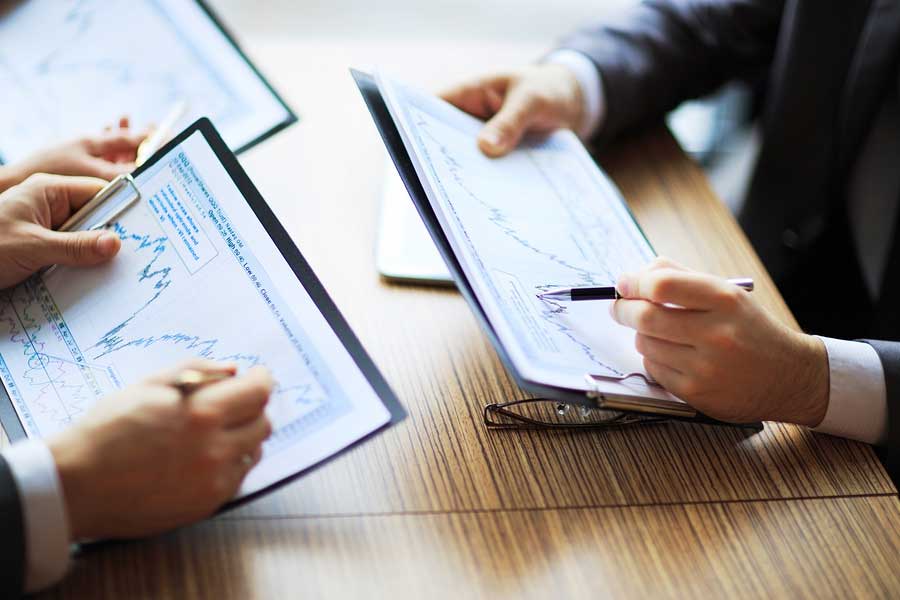 two people looking at financial papers