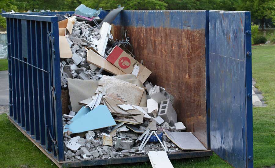 dumpster with trash in it