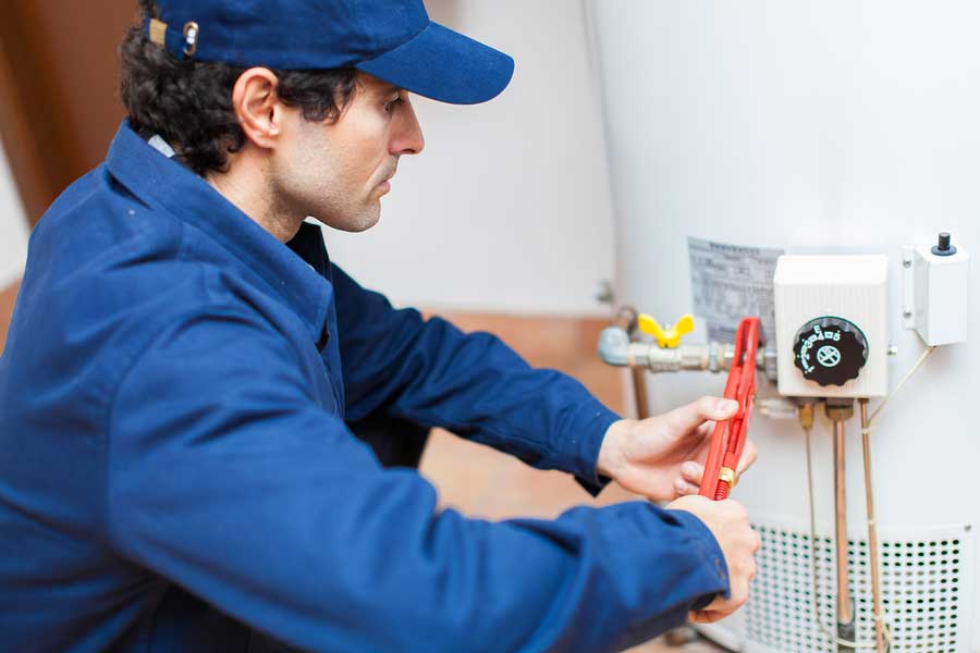 man fixing a water heater